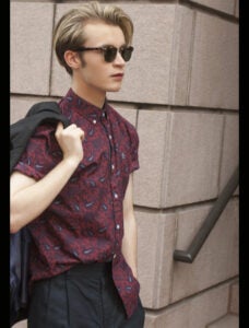 Male model portfolio shoot street style in a burgundy paisley shirt and sunglasses.